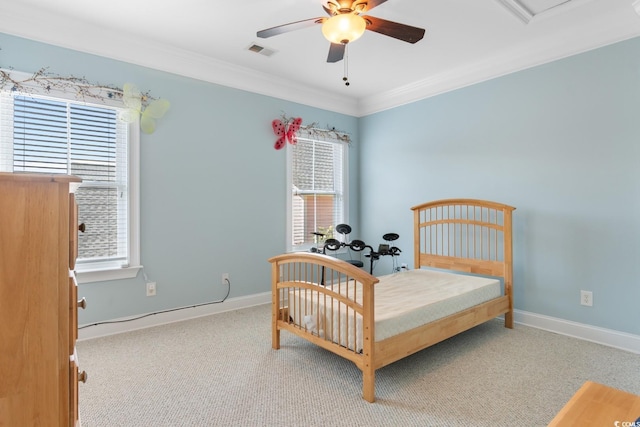 carpeted bedroom with crown molding, baseboards, and ceiling fan