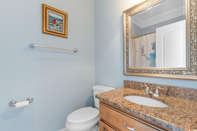 bathroom featuring vanity, toilet, and crown molding