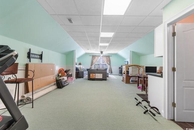 recreation room featuring carpet, vaulted ceiling, and a wainscoted wall