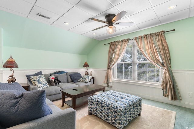 carpeted living room featuring wainscoting, a ceiling fan, and lofted ceiling