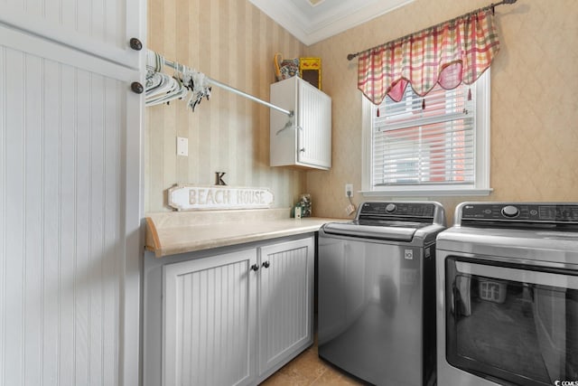 washroom with wallpapered walls, cabinet space, and washing machine and dryer