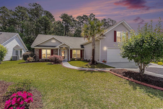 view of front of house featuring driveway, an attached garage, a front yard, roof with shingles, and cooling unit