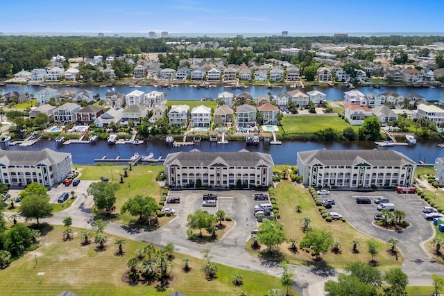 aerial view of residential area featuring a large body of water