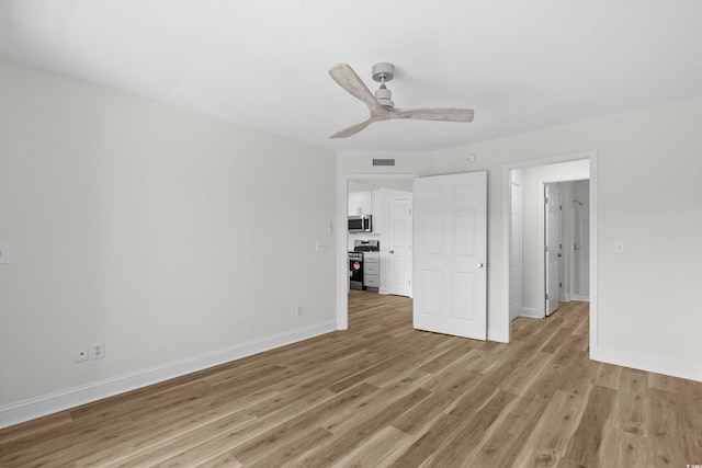 unfurnished bedroom with light wood finished floors, baseboards, and a ceiling fan