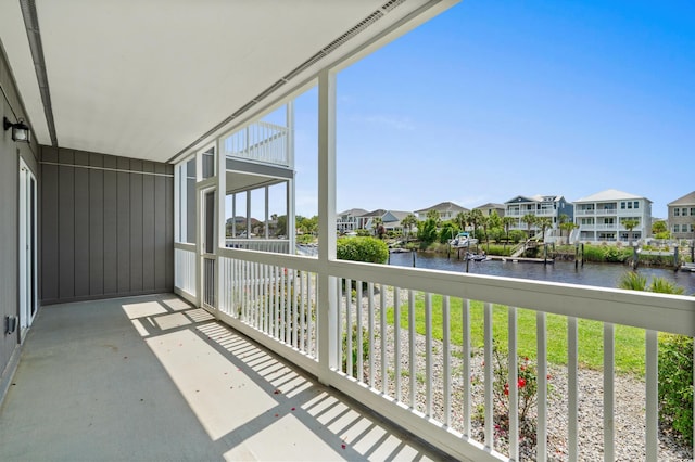 balcony featuring a water view and a residential view