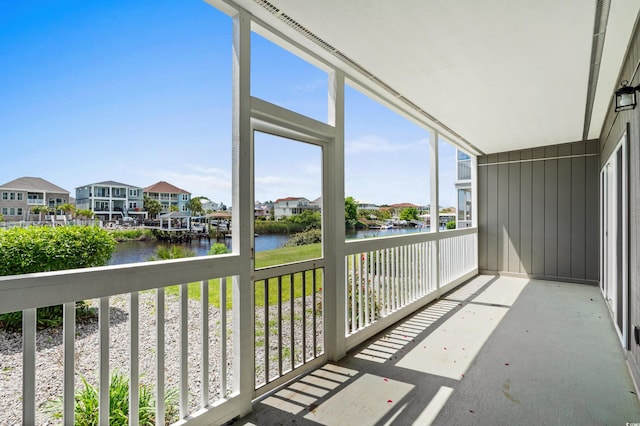 balcony featuring a water view and a residential view