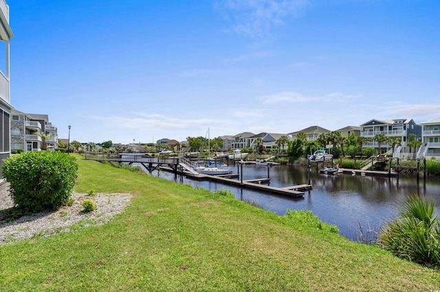 dock area featuring a lawn, a water view, and a residential view