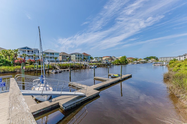 dock area featuring a water view and a residential view