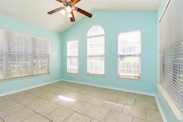 tiled spare room with ceiling fan, lofted ceiling, and baseboards