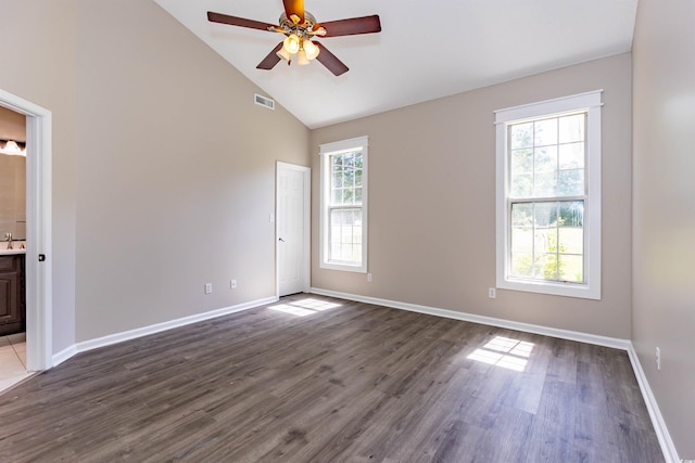spare room featuring ceiling fan, dark wood finished floors, high vaulted ceiling, baseboards, and a sink