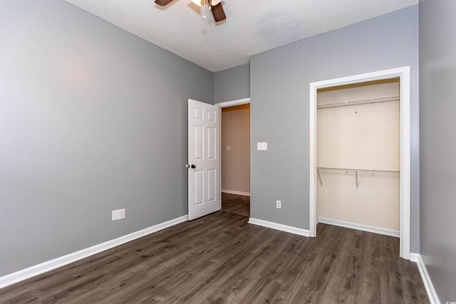 unfurnished bedroom with wood finished floors, baseboards, a closet, ceiling fan, and a textured ceiling