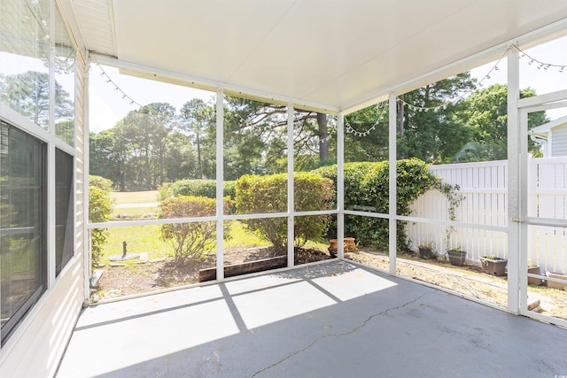 unfurnished sunroom with view of scattered trees