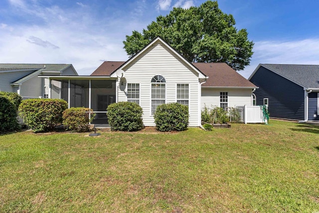 back of house featuring a sunroom and a yard