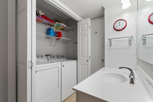bathroom with a sink and washer and clothes dryer