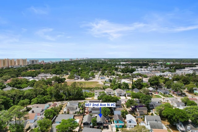 drone / aerial view of a tree filled landscape