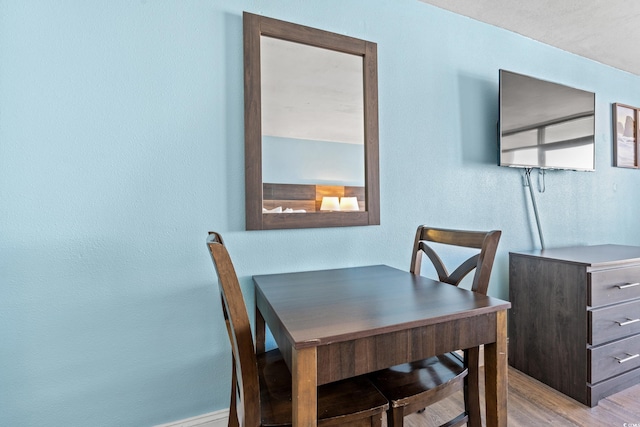 1501 S Ocean Blvd Unit 501, Myrtle Beach, SC 29577 - dining area with wood finished floors and a textured wall