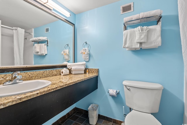 1501 S Ocean Blvd Unit 501, Myrtle Beach, SC 29577 - bathroom featuring toilet, curtained shower, vanity, and baseboards
