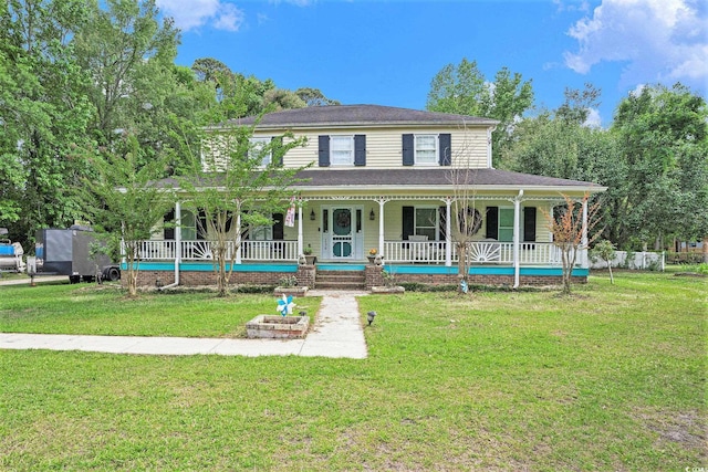 view of front facade featuring covered porch and a front yard
