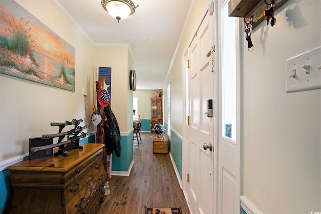 hallway with dark wood finished floors, baseboards, and ornamental molding