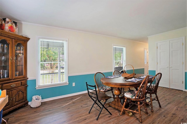 dining room with ornamental molding, dark wood-type flooring, and baseboards