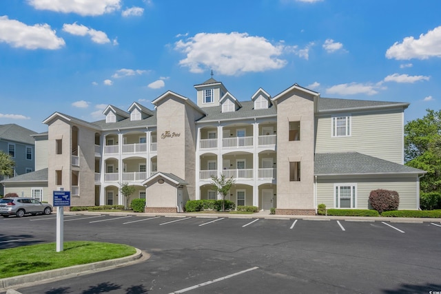 view of building exterior featuring uncovered parking