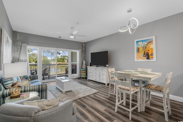 living room featuring wood finished floors, a ceiling fan, and baseboards