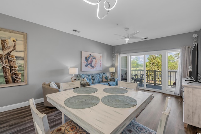 dining area featuring dark wood finished floors, a ceiling fan, and baseboards