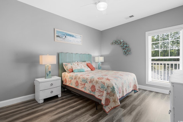 bedroom with wood finished floors, baseboards, and a ceiling fan