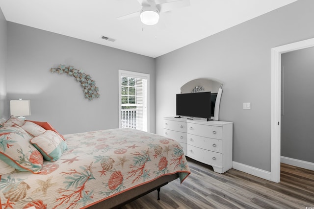 bedroom featuring wood finished floors, baseboards, and ceiling fan