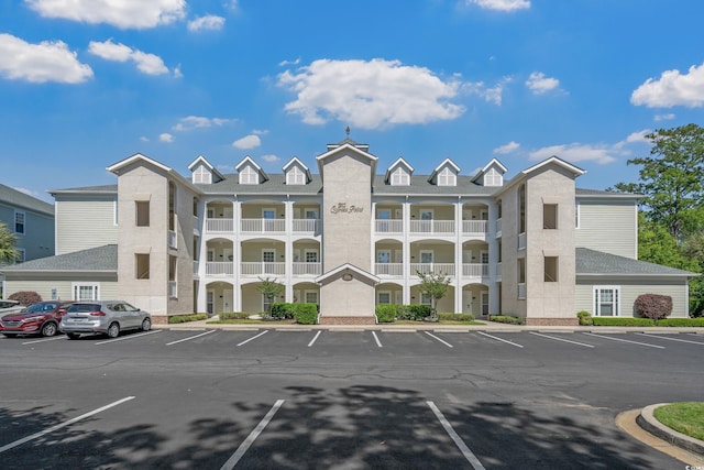 view of building exterior with uncovered parking