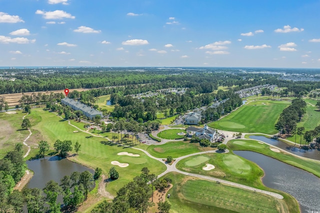 aerial overview of property's location featuring a large body of water, a forest, and a golf course