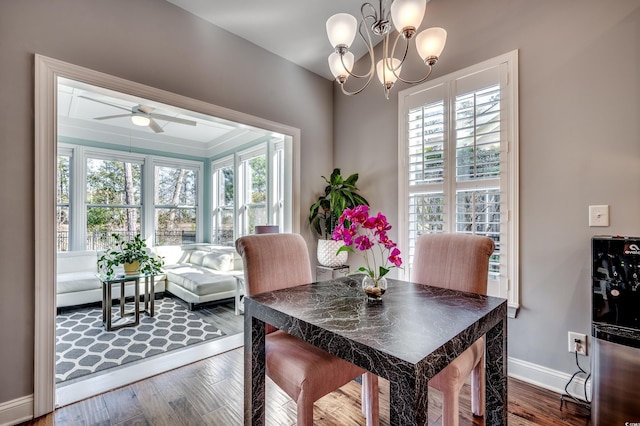 dining room with plenty of natural light, a ceiling fan, baseboards, and dark wood-style floors