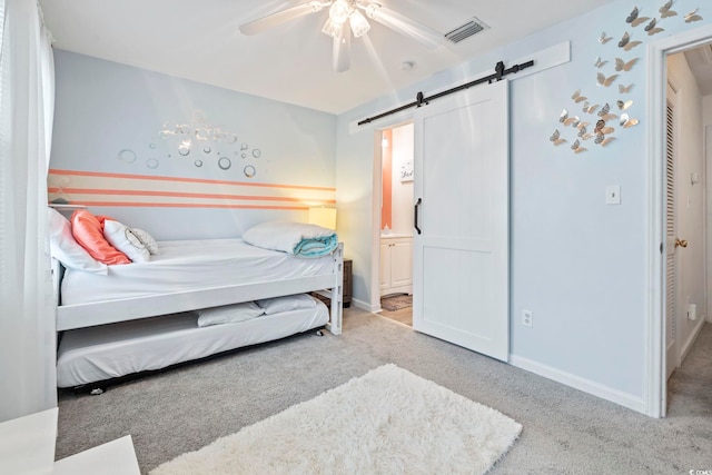 3008 Church St Unit D3, Myrtle Beach, SC 29577 - bedroom featuring a barn door, carpet, ensuite bath, ceiling fan, and baseboards