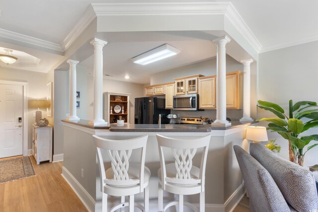 2180 Waterview Ln Unit 836, North Myrtle Beach, SC 29582 - kitchen featuring stainless steel microwave, black fridge with ice dispenser, light brown cabinets, a breakfast bar area, and ornate columns