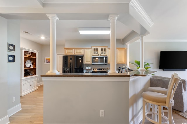 2180 Waterview Ln Unit 836, North Myrtle Beach, SC 29582 - kitchen featuring appliances with stainless steel finishes, ornate columns, a kitchen bar, glass insert cabinets, and ornamental molding