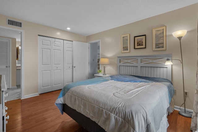 bedroom featuring baseboards, wood finished floors, a closet, a textured ceiling, and recessed lighting