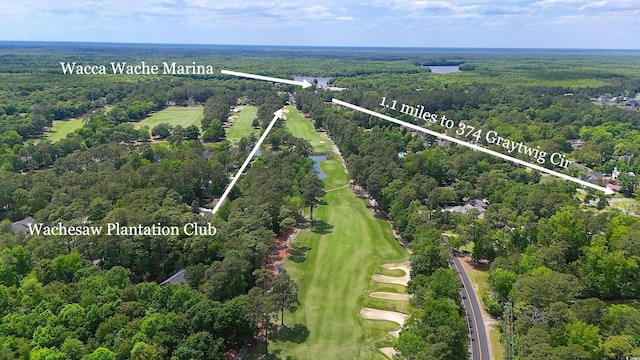 bird's eye view of a heavily wooded area, a local golf course, and a large body of water
