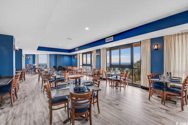dining space with wood finished floors