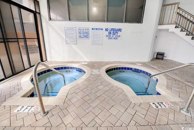 view of swimming pool featuring a community hot tub
