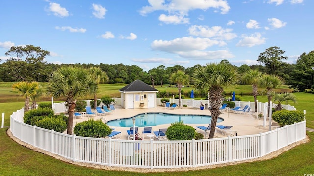 community pool featuring a patio area and view of scattered trees