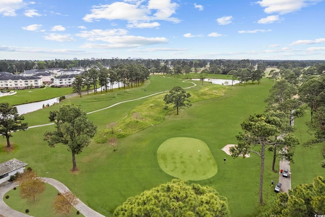drone / aerial view of a large body of water, a local golf course, and a tree filled landscape