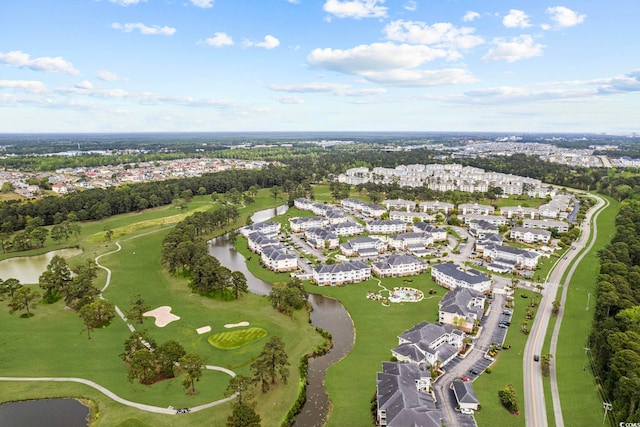 aerial view of property and surrounding area with a nearby body of water, nearby suburban area, a local golf course, and a tree filled landscape