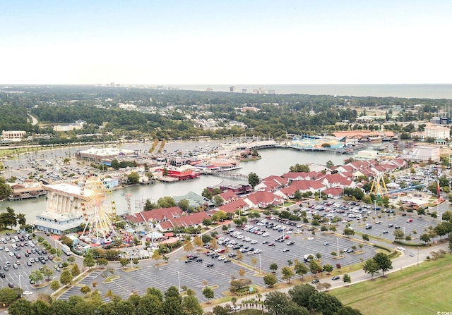aerial view of property and surrounding area featuring a large body of water and nearby urban area