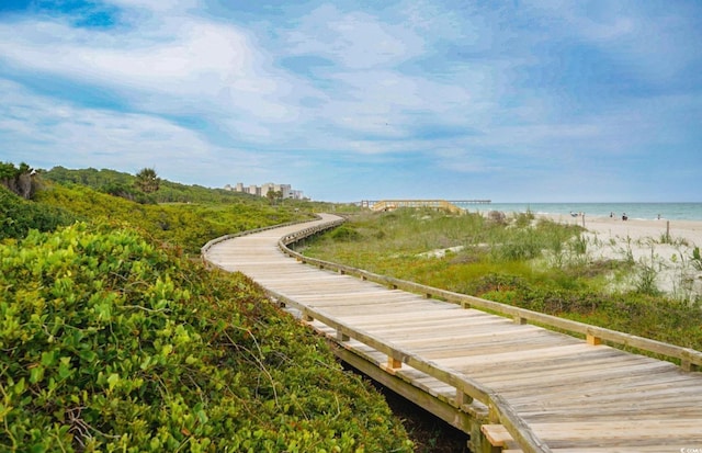 surrounding community with view of water and beach