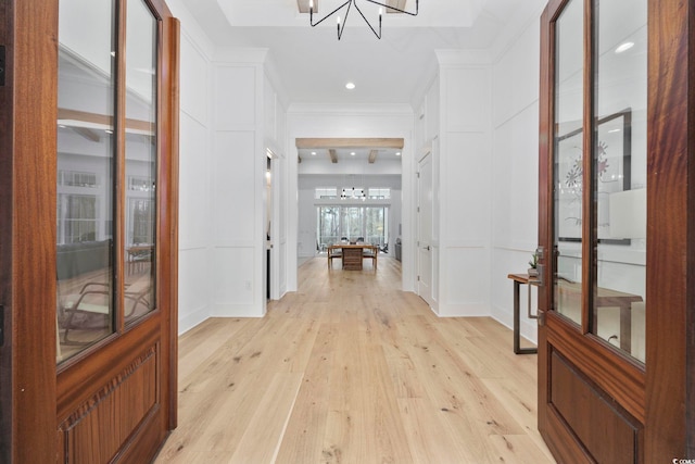 341 Brickwell Ln, Pawleys Island, SC 29585 - hall featuring a chandelier, light wood finished floors, a decorative wall, recessed lighting, and ornamental molding