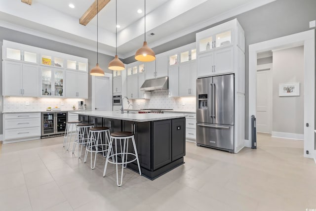 341 Brickwell Ln, Pawleys Island, SC 29585 - kitchen with high quality fridge, beverage cooler, under cabinet range hood, tasteful backsplash, and a high ceiling