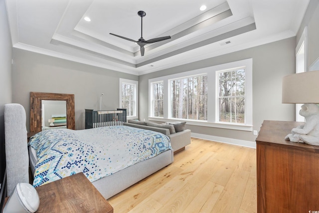 341 Brickwell Ln, Pawleys Island, SC 29585 - bedroom featuring a tray ceiling, light wood finished floors, ornamental molding, recessed lighting, and baseboards