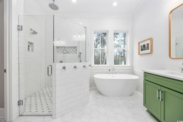 341 Brickwell Ln, Pawleys Island, SC 29585 - bathroom with a shower stall, vanity, a freestanding bath, tile patterned floors, and tile walls