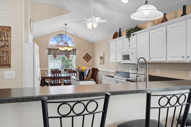 347 Kessinger Dr, Surfside Beach, SC 29575 - kitchen with white appliances, vaulted ceiling, ceiling fan, white cabinetry, and a chandelier