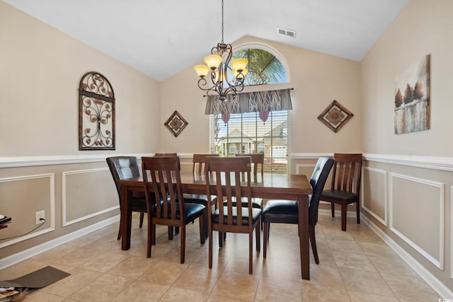 347 Kessinger Dr, Surfside Beach, SC 29575 - dining room featuring a chandelier, a decorative wall, lofted ceiling, light tile patterned floors, and wainscoting
